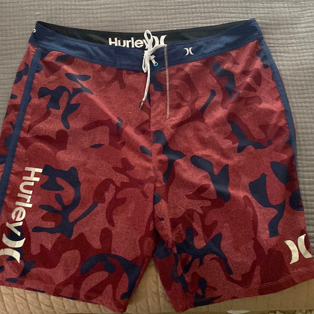 Men’s swimwear, Hurley board shorts, red/blue urban camo pattern.